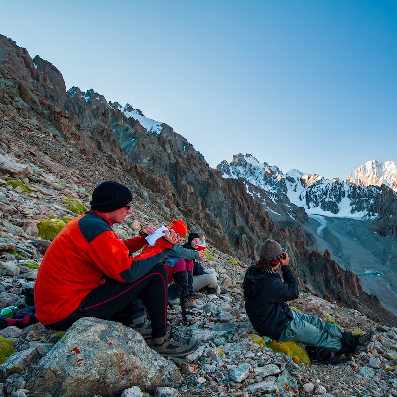 Group of trekkers climbers alpinists conquering Pik Uchitel peak from Racek Hut in Ala Archa Alpine National Park Landscape near Bishkek, Tian Shan Mountain Range, Kyrgyzstan