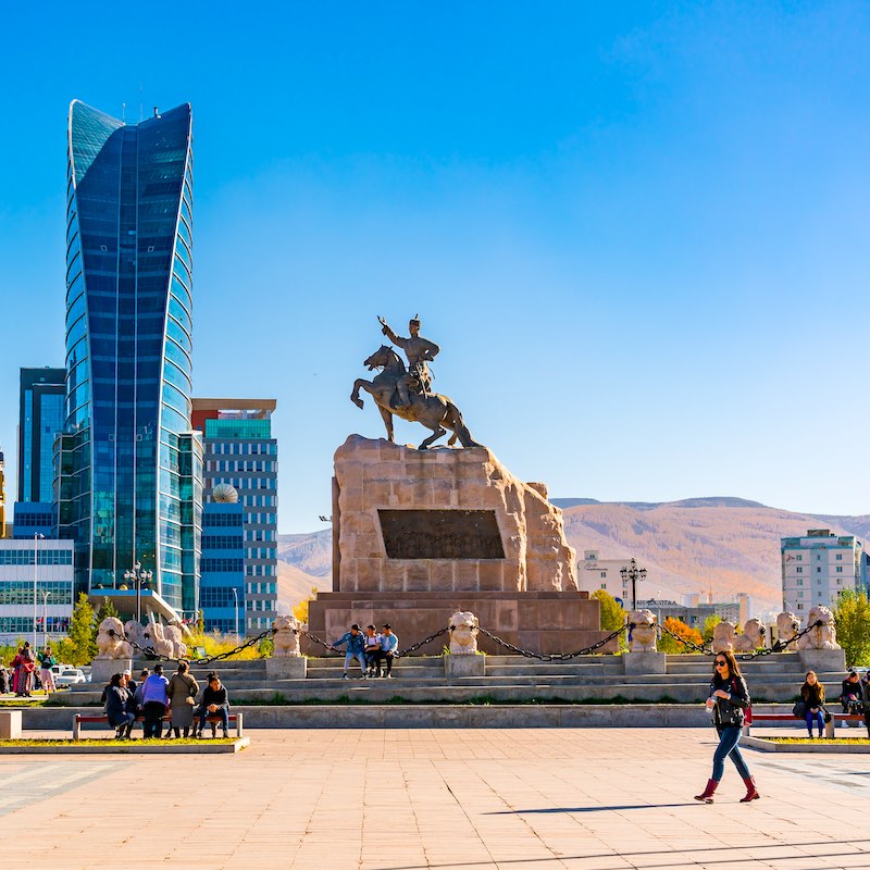 Sukhbaatar Square or Genghis Khan Square with the Statue of Mongolian revolutionary hero Sukhbaatar and the cityscape of Ulaanbaatar in Mongolia
